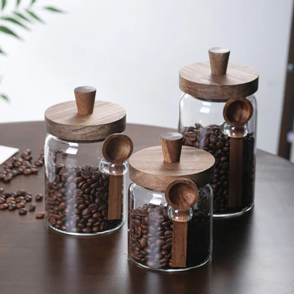 Premium glass storage jar set with wooden lids filled with coffee beans