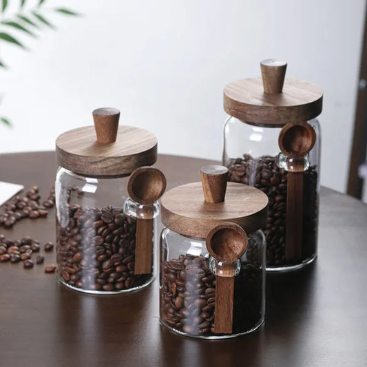 Premium glass storage jar set with wooden lids filled with coffee beans