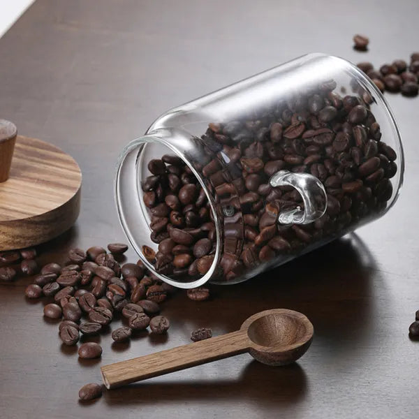 Glass storage containers with wooden lids styled with coffee accessories