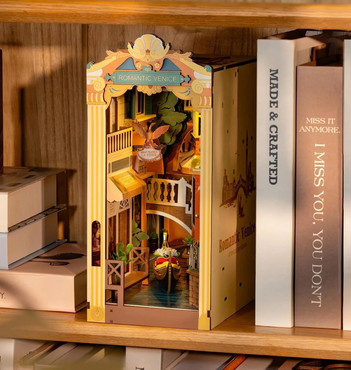 Romantic Venice book nook displayed between books on shelf